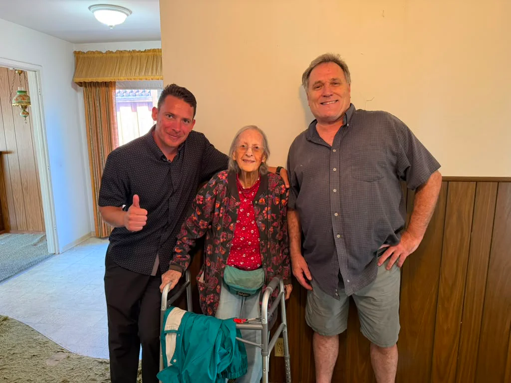 Two NextKey team members with a homeowner after meeting in her home
