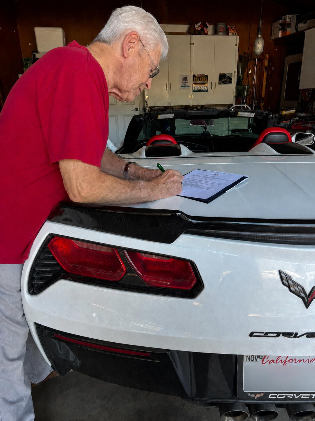 A homeowner reviewing and signing sale paperwork