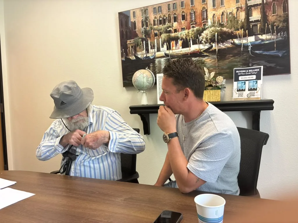 Edward from NextKey Home Offer talking with a homeowner during an in-person consultation