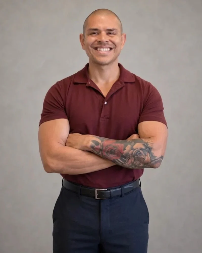 Alex, COO of NextKey Home Offer, smiling with his arms crossed in a maroon polo